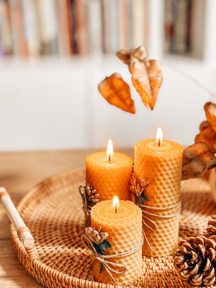 services-img Warm autumn scene with handmade beeswax candles on a wicker tray, evoking a cozy atmosphere.
