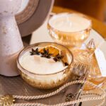 Elegant decor featuring glass candles with spices and orange slices, perfect for a cozy ambiance.