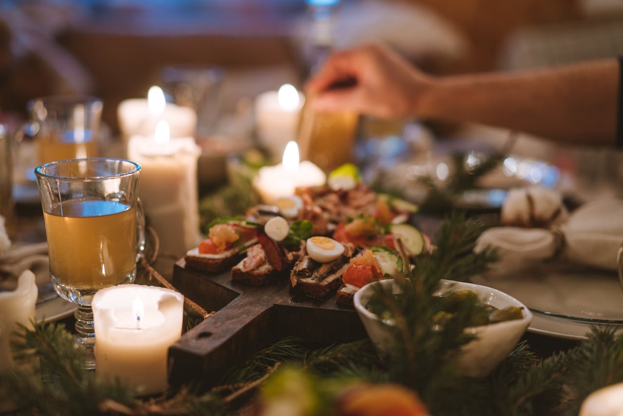 our-services-3 A cozy holiday dinner setting featuring candles, festive food, and a warm atmosphere.