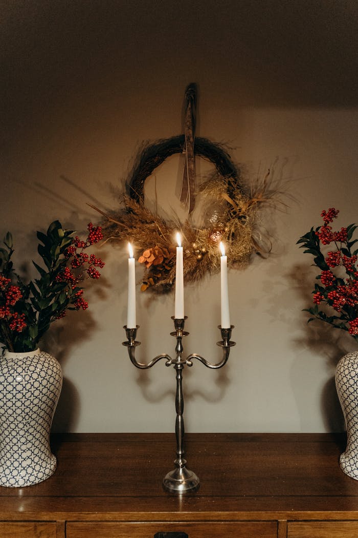 our-services-2 A beautifully arranged candlelit centerpiece with floral vases and a rustic wreath.