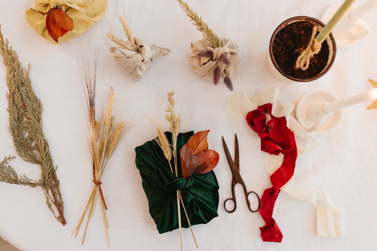 contact-img Flat lay of eco-friendly gift wrapping using natural materials, leaves, and fabric.